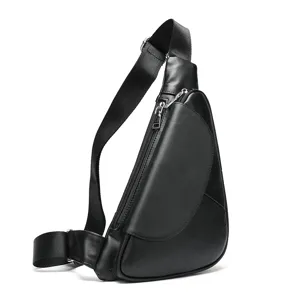 Close-up detail of black leather sling chest bag with metal zipper and adjustable strap.
