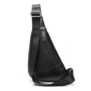Leather sling bag detail showing side profile, adjustable strap, and metal zipper pocket.