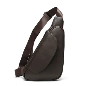 Leather chest bag detail showing premium brown texture, metal zipper and adjustable strap.