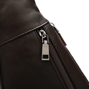 Close up view of brown genuine leather bag with durable metal zipper and fine stitching details.