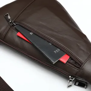 Detailed view of dark brown leather chest bag showing zipper pocket and smooth texture.