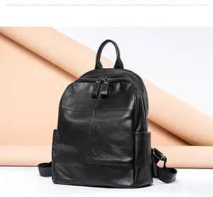 Detailed view of the black genuine leather backpack showing fine texture, zipper and strap.
