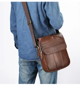 Details of the brown leather men's shoulder messenger bag showing fine stitching and durable strap.