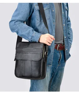 Men's black leather vertical shoulder bag worn on torso showing casual daily commute style.