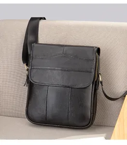 Detailed view of men's genuine leather vertical crossbody bag showing exquisite grain texture.