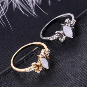 Women fashion alloy rings set with white marquise opal and clear cubic zirconia stones.