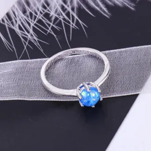 Stunning minimalist blue opal ring featuring a round gemstone in silver prong setting for women.