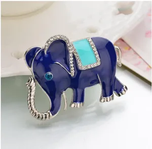 Detailed closeup of a fashion blue enamel rhinestone elephant brooch with turquoise saddle style.