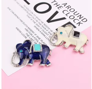 Detail shot of cute elephant rhinestone enamel brooch pin in blue and white colors.