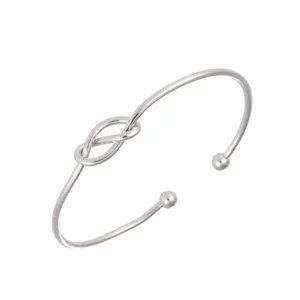 Minimalist silver open cuff bracelet with a stylish knot design and smooth metal finish.