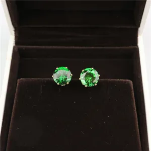 Detailed close-up of vibrant green round 8mm cubic zirconia stud earrings in a velvet box.