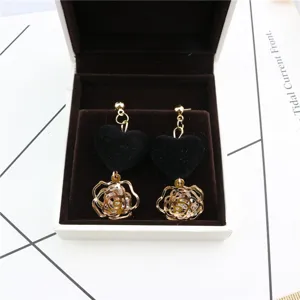 Black velvet heart and gold hollow rose zircon earrings detail. Sweet and elegant jewelry piece.
