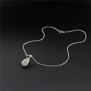 Detailed view of a sparkling rhinestone teardrop pendant necklace on a sleek silver snake chain.