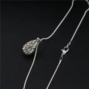 Detail shot of silver snake chain necklace with rhinestone paved teardrop pendant jewelry