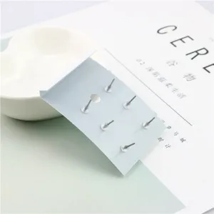 Minimalist stud earrings set display detail view, showing secure backing pins and stoppers.