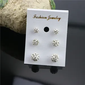 White rhinestone Shamballa ball stud earrings set detail display with three pairs of sparkly studs.