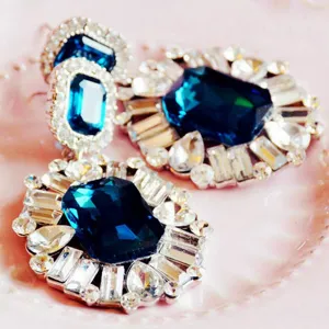 Closeup detail of luxury vintage dark blue crystal rhinestone statement earrings for women.