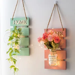 Wall hanging wooden planter with artificial flowers and LED string lights for home indoor decor.
