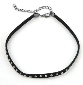 Close-up detail of black suede velvet choker necklace with metal rivets and chain.