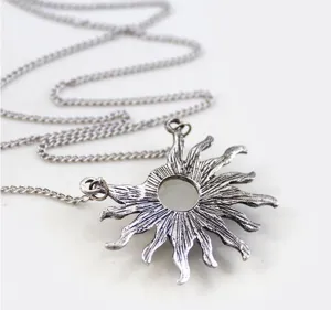 Detailed close-up shot of the vintage silver sun pendant necklace, showing fine craftsmanship.