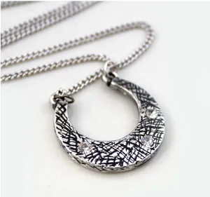 Vintage horseshoe pendant necklace with sparkling rhinestones, retro silver chain jewelry.