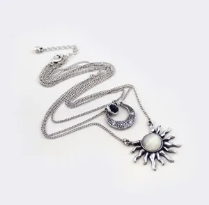 Retro multi-layer necklace for women featuring sun and moon pendants, vintage silver sweater chain.