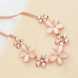 Close-up view of the rose gold cat eye stone flower necklace, showing the delicate petals and chain.