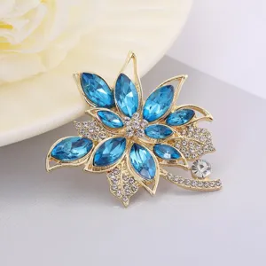 Exquisite blue rhinestone flower brooch, elegant gold tone alloy pin for women's fashion wear.