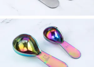 Close-up detail of colorful stainless steel measuring spoons with clear engraved capacity marks.
