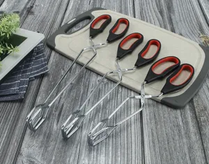 Stainless steel kitchen food tongs with ergonomic red and black anti-slip handle design.
