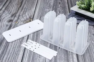Detailed view of 4-cavity homemade popsicle mold with lid and sticks for summer DIY ice cream.