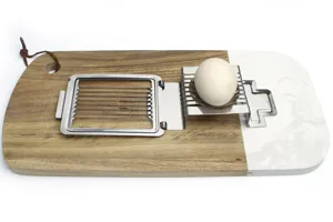 Stainless steel egg slicer detail showing cutting wires and metal frame on a wooden background.