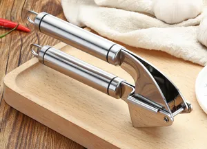 Stainless steel garlic press detail view, kitchen gadget for mincing, durable and easy to clean.
