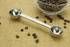 Stainless steel double-ended measuring spoon with clear scale for coffee scoops and kitchen use.