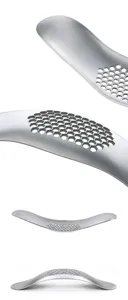 Stainless steel garlic press detail showing hexagonal mesh holes and smooth curved rocker body.