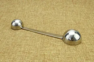 Stainless steel double-ended measuring spoon detail shot, perfect for coffee and kitchen use.