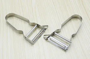 Stainless steel vegetable peeler detail shot, dual blade kitchen tool for fruit.