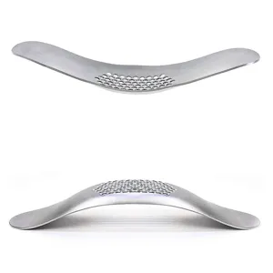 Stainless steel curved garlic press rocker manual kitchen tool for fast and easy mincing.