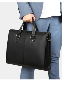 Detalle cercano de maletín de negocios de cuero negro con textura elegante y asas dobles.