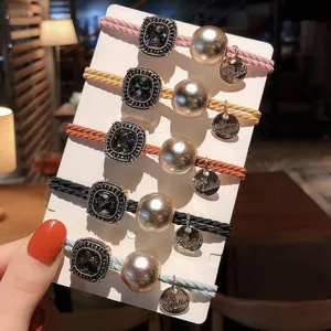 Detailed view of fashionable Korean style hair ties with square crystal and pearl charms.