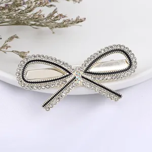 Rhinestone bow hair clip for women, sparkling crystal alloy duckbill clip, elegant hair accessory.