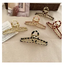 Korean fashion metal hair claw clip with woven fabric detail, elegant hair accessory.