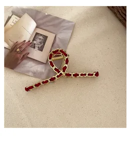 Red velvet and gold chain hair claw clip, elegant shark clip for women and girls daily styling.
