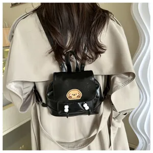 Mini black PU leather backpack with cute dog embroidery and white bead charms detail.