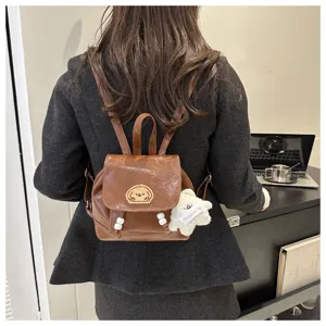 Detailed view of trendy brown mini backpack with cute dog patch, perfect for daily commuting.
