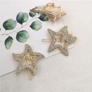 Close-up detail of stylish rhinestone star hair clips with elegant hollow design and sparkling stones.