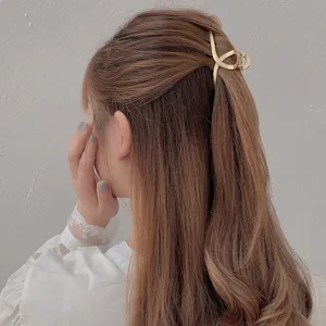Minimalist gold metal hair claw clip, elegant geometric hollow hairpin for stylish half-up hairstyles.