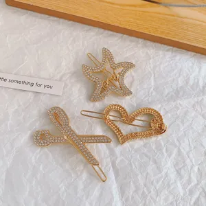Gold rhinestone hair clips set featuring star, heart, and scissor shapes for stylish girls.