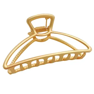 Matte gold metal hair claw clip, elegant geometric hair accessory for women styling.