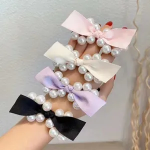 Pearl bow hair tie detail, elegant satin ribbon with synthetic pearls, soft elastic hair band.